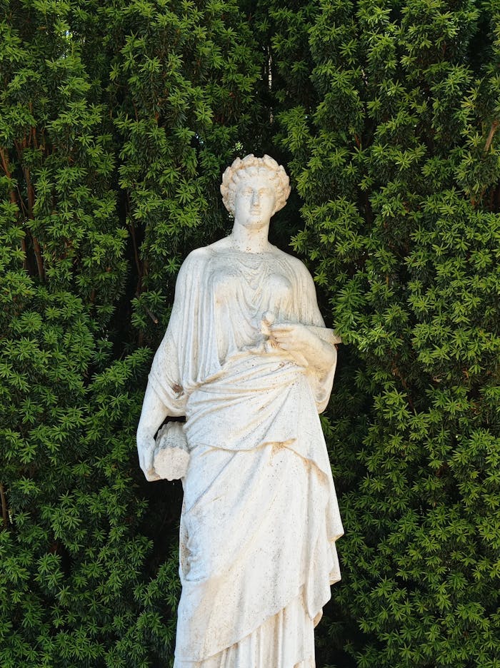Elegant marble statue against lush greenery in Lota, Chile.